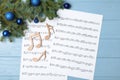 Composition with wooden music notes and Christmas balls on table Royalty Free Stock Photo