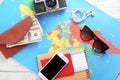 Composition with world map, money and passport on table. Travel concept