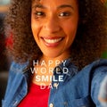 Composition of world smile day text over biracial woman smiling