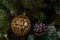 Composition of Xmas toys cones and branches of spruce. Glowing garland. Close-up Royalty Free Stock Photo