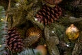 Composition of Xmas toys cones and branches of spruce. Glowing garland. Close-up Royalty Free Stock Photo