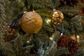 Composition of Xmas toys cones and branches of spruce. Glowing garland. Close-up Royalty Free Stock Photo