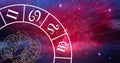 Composition of zodiac wheel with pisces star sign over stars Royalty Free Stock Photo