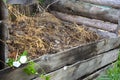 Compost heap. Wooden pit for humus food and garden waste and grass Royalty Free Stock Photo