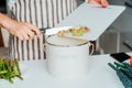 Compost the kitchen waste, recycling. Household woman scraping, throwing vegetables cutting leftovers into the garbage