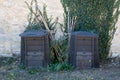 Compost recycled plastic duo composter at the bottom of the garden silos backyard Royalty Free Stock Photo
