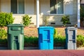 Compost, recycling and garbage carts set outside of the home on the curb for residential garbage and recycling pickup