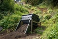 composter tumbling down a hillside, with garden at the bottom Royalty Free Stock Photo