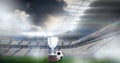 Compostion of cup and football over stadium and white blur Royalty Free Stock Photo