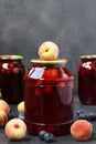 Compote with peaches and berries of blackthorn in cans.