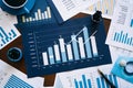 Comprehensive financial data analysis desk with blue and white bar graphs and numerical data. Royalty Free Stock Photo