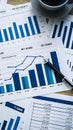 Comprehensive financial data analysis desk with blue and white bar graphs and numerical data. Royalty Free Stock Photo