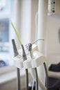 Compressed nozzle air and saliva ejector and other tools hoses on stand in dentist's office. Royalty Free Stock Photo