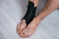 compression fixed in ankle stabilizer medical bandage. Fracture or Leg sprain injury of young sports man Royalty Free Stock Photo