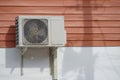 Compressor air conditioner hanging on the wooden wall Royalty Free Stock Photo