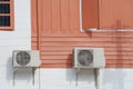 Compressor air conditioners hanging on the wooden wall outside the house Royalty Free Stock Photo