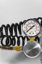 Compressor pressure gauge with black pipes. Royalty Free Stock Photo