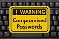 Comprised Passwords message on a sign on a computer keyboard