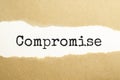 compromise appearing behind torn brown paper Royalty Free Stock Photo