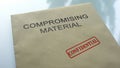 Compromising material confidential, seal stamped on folder with documents Royalty Free Stock Photo