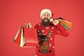 Compulsive buyer. Retail. Almost christmas. Presents for family. Bearded hipster carry shopping bags. Santa man bought Royalty Free Stock Photo