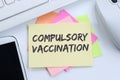 Compulsory vaccination against coronavirus vaccine hesitancy corona virus COVID-19 Covid computer note paper Royalty Free Stock Photo