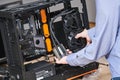 Computer assembling service. Serviceman installing liquid cooling system on processor