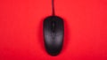 Computer black mouse on red background top viewn Royalty Free Stock Photo