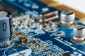 Computer blue motherboard with microchips, capacitors and various electronic components, side view Royalty Free Stock Photo