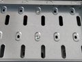 Computer case close up. Metal surface with ventilation holes. Places for fastening with screws. Silver-colored metal. Computer Royalty Free Stock Photo