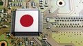 Computer chip on PCB board with Japan flag. CPU Central processing Unit or GPU microchip on a motherboard Royalty Free Stock Photo