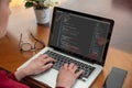 Computer code, software. Woman programmer work on a laptop, office background, close up Royalty Free Stock Photo