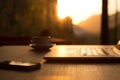 Computer Coffee Mug and Telephone on black wood table sun rising Royalty Free Stock Photo