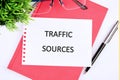 Computer concept. TRAFFIC SOURCES words close-up, on a white sheet of notepad Royalty Free Stock Photo