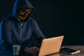 Anonymous hacker man with laptop