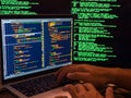 Computer crime concept, hacker breaching secure system using malicious code or virus program