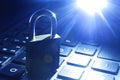 Computer or data analysis - Padlock over a laptop computer keyboard toned in blue Royalty Free Stock Photo