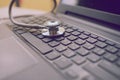 Computer or data analysis - Stethoscope over notebook keyboard Royalty Free Stock Photo