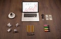 Computer desk with laptop and red arrow chart in screen Royalty Free Stock Photo