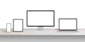 Computer display, laptop, tablet and phone on desk with isolated, blank screens for responsive app or web page design promotion Royalty Free Stock Photo