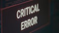 Computer displaying critical error message flashing on screen after cyber crime attack Royalty Free Stock Photo