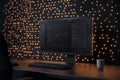 A computer displays code and a graph against a wall of warm lights Royalty Free Stock Photo