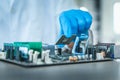 Computer engineer assembly microprocessor CPU into electronic motherboard., Close-up of technician putting microchip to circuit