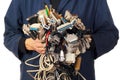 Computer engineer holding many different cables wires connectors