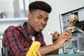 Computer engineer repairing motherboard at desk in office Royalty Free Stock Photo