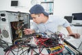 Computer engineer working on broken console with laptop Royalty Free Stock Photo