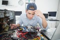 Computer engineer working on broken console with laptop Royalty Free Stock Photo