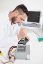 Computer engineer working on broken cpu with screwdriver Royalty Free Stock Photo