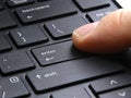 Computer enter key with finger pressing button Royalty Free Stock Photo