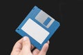 Computer floppy disk in Hand on black background. Royalty Free Stock Photo